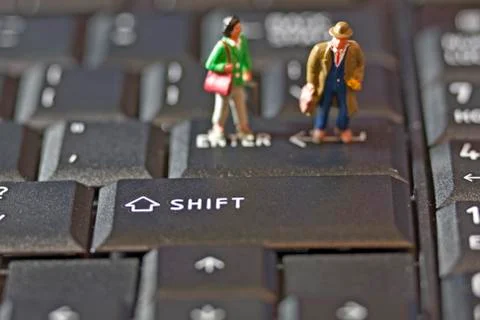 Two figures on keyboard Stock Photos