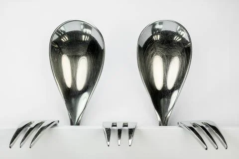 Two figures made of spoons and forks. Stock Photos