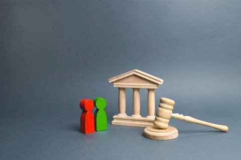 Two figures of people opponents stand near the courthouse and the judge's g.. Stock Photos