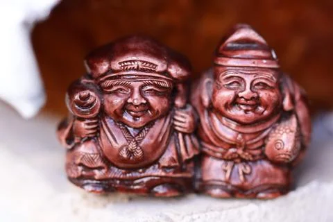 Two figurines sit together, often used as decorative objects or collectibles Stock Photos