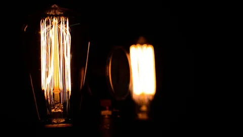 Two filament light bulbs side view switch on gradually increase and off Stock-Footage 127886345
