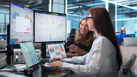 Two Financial Analysts Discuss KPI Dashboard Insights During Collaborative Stock Footage 341006666