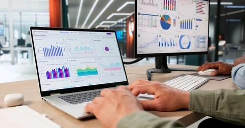 Two Financial Analysts Looking At Data Dashboard To Improve Business Decision Stock Photos