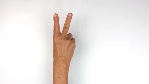 Two finger gesture by senior hand on white background Stock Footage 146578153
