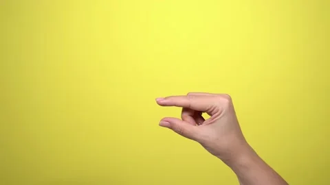Two fingers gesturing as if showing different sizes of virtual objects Stock Footage 143568741