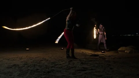 Two fire artists perform different pieces at the same time Stock Footage 145585985