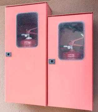 Two fire extinguishers in their lockers Stock Photos