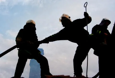 Two fire fighters and flames 스톡 사진