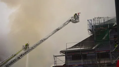 Two fire ladders during a building fire Stock Footage 144377627