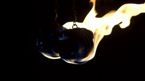 Two fireballs hang on chains and spin around their axis. Balls are burning 스톡 동영상 140199238
