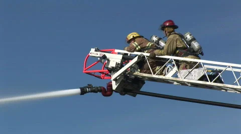 Two firefighters on crane Stock Footage 66106