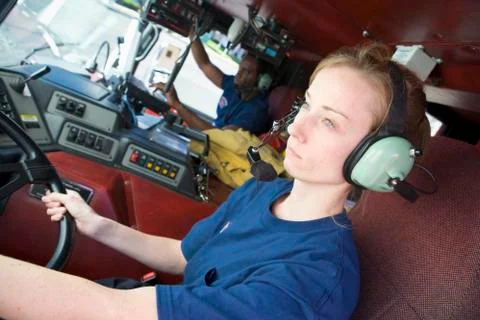 Two firefighters in fire engine (selective focus) Stock Photos