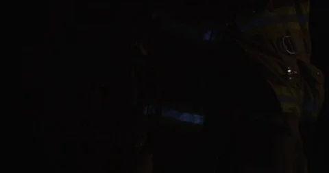 Two firefighters in full tactical gear guide their way with a flashlight. Stock Footage 69216437