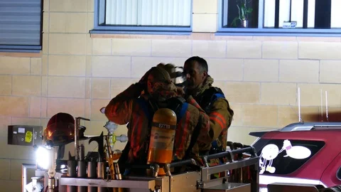 Two firefighters hurrying to put mask on Stock Footage 116077281