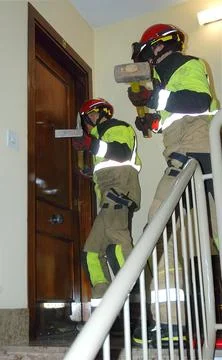 Two Firefighters Performing Forced Entry Door Breach Training Exercise on R.. Stock Photos
