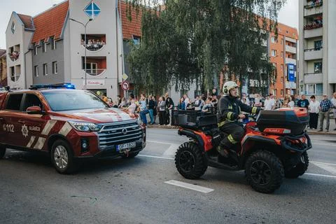 Two firefighters in protective gear stand next to. Stock Photos