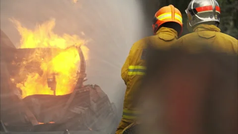 Two firefighters standing in position while directing a powerful water Stock-Footage 326217786
