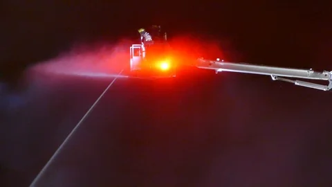 Two firefighters watering from a platform Stock Footage 90359834