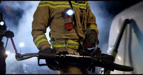 Two Fireman Walking Towards Burning Car Stock Footage 143542215