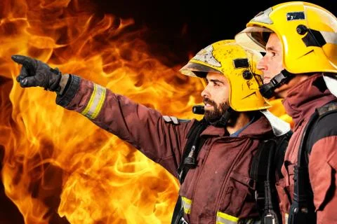 Two firemen analyzing fire. Stock Photos