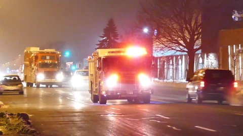 Two firetrucks with flashing lights arrive at commercial building Stock Footage 77884540