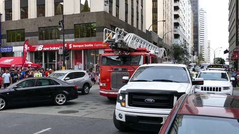 Two firetrucks passing threw dense traffic downtown Stock-Footage 95735060