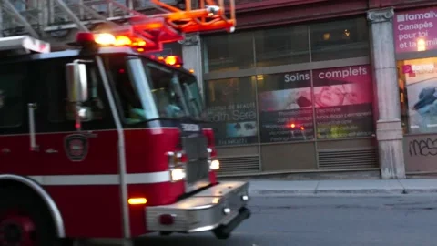 Two firetrucks respond with lights in different direction during protest in city Stock Footage 137553564