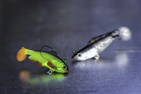 Two fish bait plastic hooks on a dark gray background Stock Photos