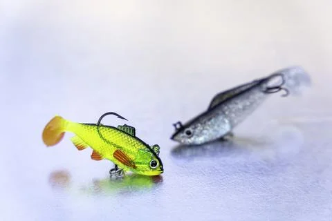 Two fish bait plastic hooks on a light blue background Stock Photos