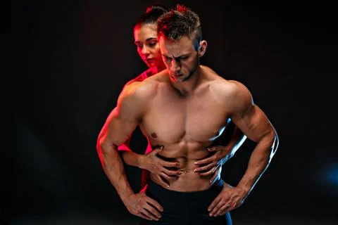 Two fit sportspeople posing together, close to each other. Studio portrait Stock Photos