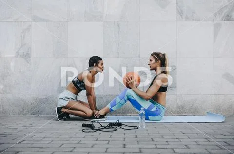 Two fitness women training outdoors Stock Photos
