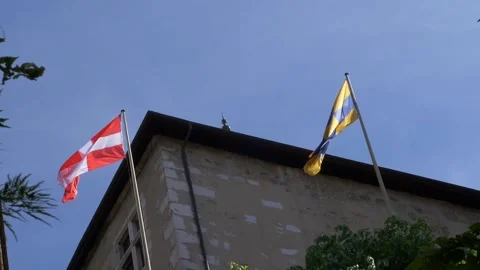 Two flag with switzerland flag and top of castle and blue sky. Shot in slow m Stock Footage 155376294