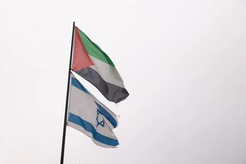 Two flags are flying side by side, one of which is the Israeli flag Stock Photos
