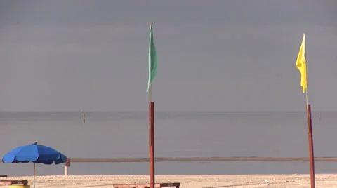 Two flags on a beach flapping in the wind Video stock 37364185