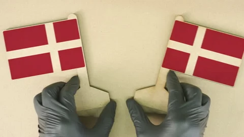 Two flags of Denmark made of recycled paper on the cardboard table Stock Footage 143258898
