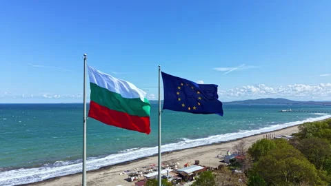 Two flags flutter on poles by the sea showing the Bulgarian flag and the Video stock 337874773