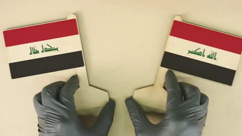 Two flags of Iraq made of cardboard on the desk Stock Footage 142751148