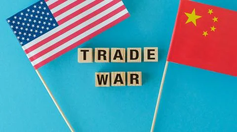 Two flags, one from the United States and one from China, with the word Tra.. Stock Photos