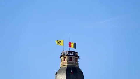 Two flags waving in the wind on top of a high church tower Stock Footage 152978046