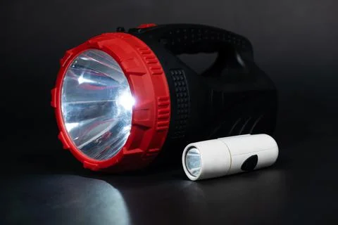 Two flashlights shine on a black background place for text Stock Photos