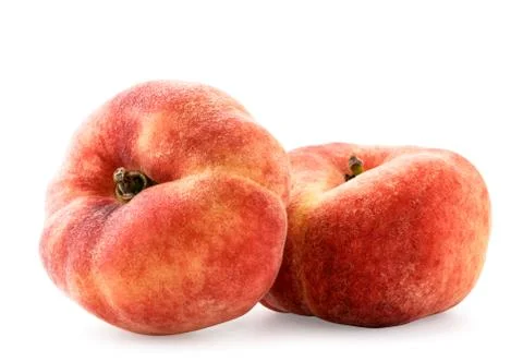 Two flat peaches on a white background, isolated. Stock Photos