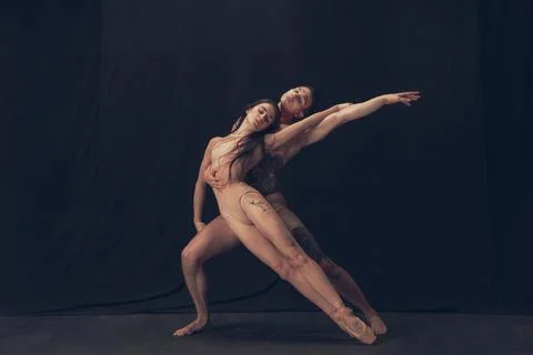 Two flexible dancer, young man and woman in modern art performance isolated on Stock Photos
