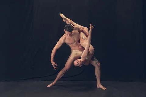 Two flexible dancer, young man and woman in modern art performance isolated on Stock Photos