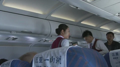 Two flight attendants on East China Airlines serve drinks, 4K. Stock Footage 88058366