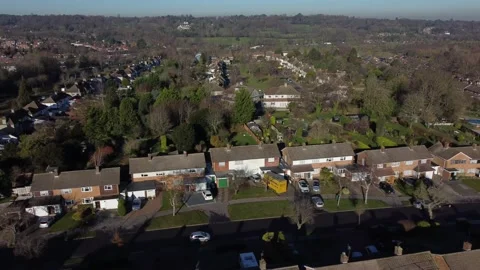 Two flocks of birds fly past on panning footage of Croydon Suburbia Stock Footage 170001161