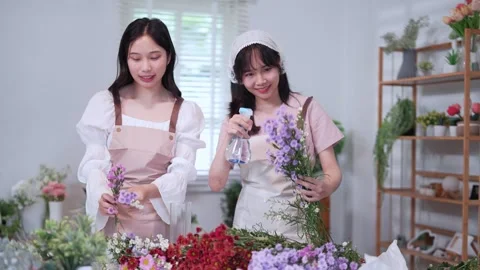 Two florists carefully creating floral arrangements with colorful flowers, .. Stock Footage 296754445