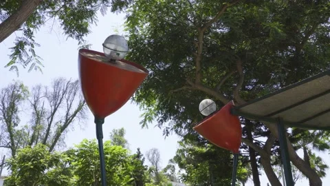 Two flower-shaped lighthouses with a spotlight in a city park 库存影片 150664584
