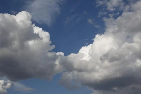 Two fluffy clouds Stock Photos