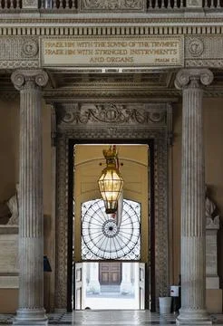 Two fluted Ionic columns frame an intricately carved stone doorway. Inside,.. 스톡 사진