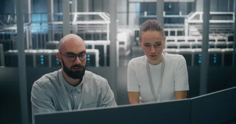 Two Focused IT Specialists Jointly Analyzing System Logs or Security Data on Video stock 325427635